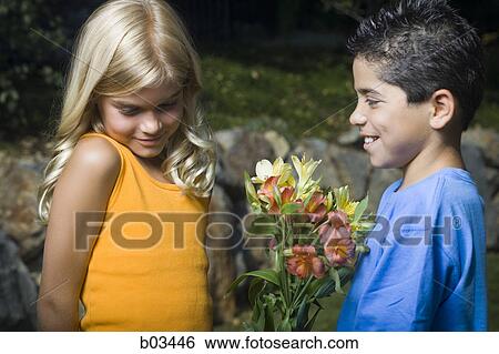 Stock Photograph - Young couple walking on the street. Fotosearch