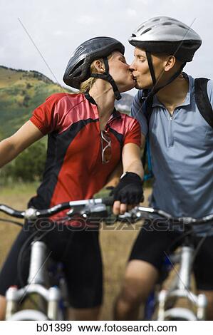 Couple kissing while mountain biking View Large Photo Image Stock Photo - Couple kissing while mountain biking. Fotosearch