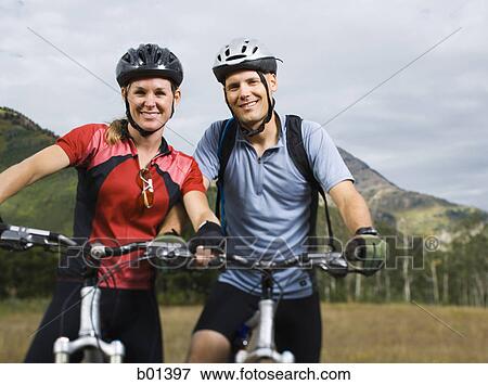 Portrait of a couple mountain biking View Large Photo Image Stock Photo - Portrait of a couple mountain biking. Fotosearch