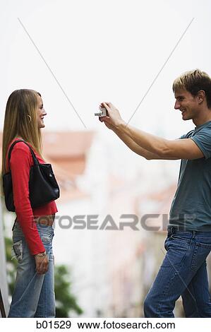 Portrait of a teenage boy taking a photograph of a teenage girl View Large Photo Image Stock Photo - Portrait of a teenage boy taking a photograph of a teenage girl. Fotosearch