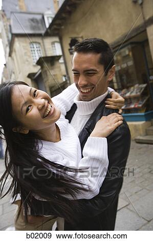 Stock Photo - Portrait of a young couple embracing each other. Fotosearch
