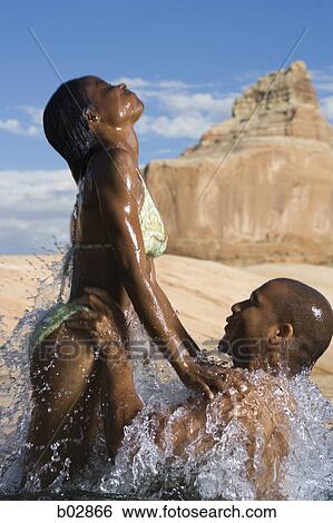 Profile of a young couple in a lake View Large Photo Image Stock Photograph - Profile of a young couple in a lake. Fotosearch