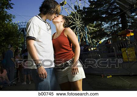 Side profile of a young man standing in an amusement park View Large Photo Image Stock Photography - Side profile of a young man standing in an amusement park. Fotosearch
