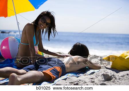 Stock Photography - Young couple on the beach. Fotosearch