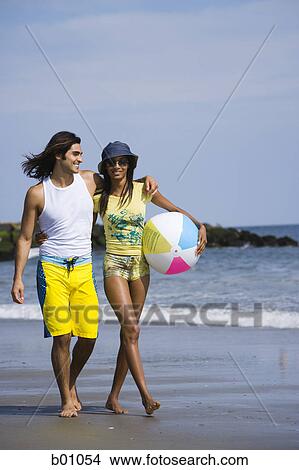 Young couple walking on the beach View Large Photo Image Picture - Young couple walking on the beach. Fotosearch
