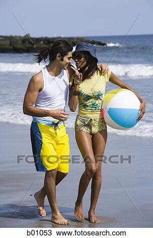 Young couple walking on the beach View Large Photo Image Stock Image - Young couple walking on the beach. Fotosearch