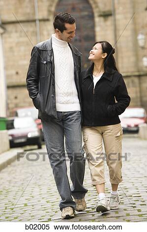 Stock Photography - Young couple walking on the street. Fotosearch