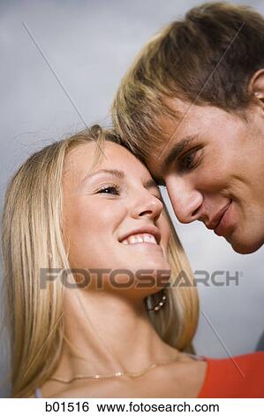 Close-up of a teenage couple smiling at each other View Large Photo Image Stock Photograph - Close-up of a teenage couple smiling at each other. Fotosearch