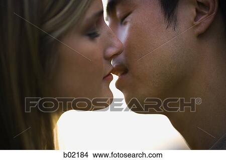 Close-up of a young man and woman kissing View Large Photo Image Picture - Close-up of a young man and woman kissing. Fotosearch