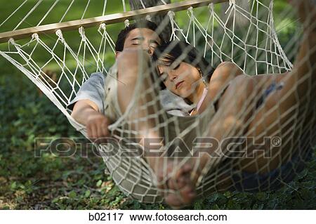 High angle view of a young couple relaxing in a hammock View Large Photo Image Stock Photo - High angle view of a young couple relaxing in a hammock. Fotosearch