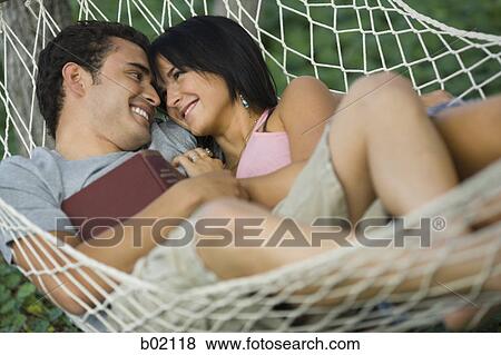 High angle view of a young couple relaxing in a hammock View Large Photo Image Stock Photo - High angle view of a young couple relaxing in a hammock. Fotosearch