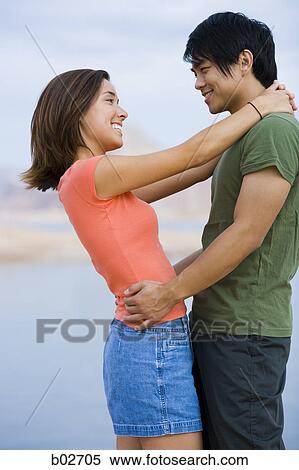 Profile of a young couple looking at each other View Large Photo Image Stock Photography - Profile of a young couple looking at each other. Fotosearch