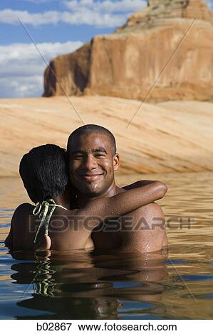 Young couple embracing in a lake View Large Photo Image Stock Photo - Young couple embracing in a lake. Fotosearch