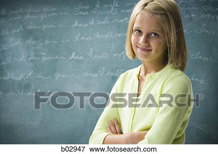Stock Photo - A young girl happy at school. Fotosearch