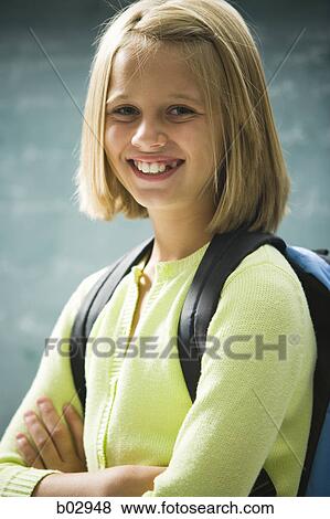 Stock Photo - A young girl happy at school. Fotosearch