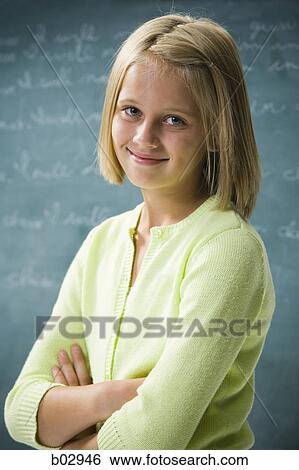 Stock Photograph - A young girl happy at school. Fotosearch