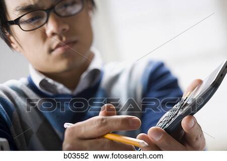 Stock Image - Close-up of a young woman listening to music on headphones. Fotosearch