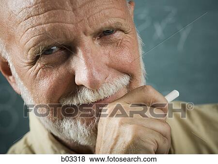 Portrait of a senior male professor holding a chalk View Large Photo Image Stock Photo - Portrait of a senior male professor holding a chalk. Fotosearch