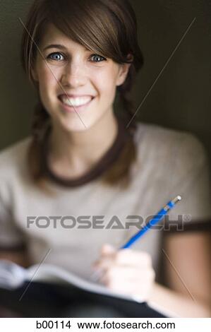Portrait of a young woman smiling View Large Photo Image Picture - Portrait of a young woman smiling. Fotosearch