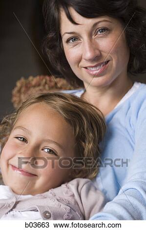 Stock Image - High angle view of a young couple relaxing in a hammock. Fotosearch
