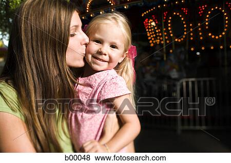 Stock Photo - Mother kissing her daughter. Fotosearch