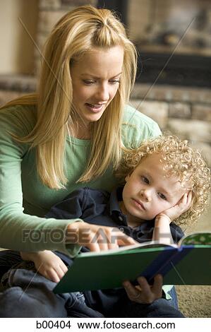 Mother reading a book with her son View Large Photo Image Picture - Mother reading a book with her son. Fotosearch
