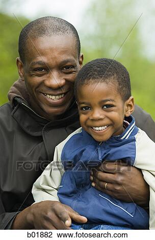 Portrait of a father and his son smiling View Large Photo Image Stock Image - Portrait of a father and his son smiling. Fotosearch