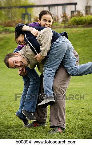 Portrait of a father playing with his kids View Large Photo Image Picture - Portrait of a father playing with his kids. Fotosearch