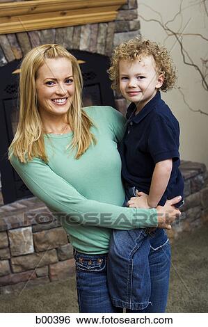 Stock Photograph - Portrait of a mother carrying her son. Fotosearch