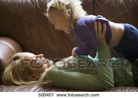 Side profile of a mother lifting her daughter View Large Photo Image Stock Image - Side profile of a mother lifting her daughter. Fotosearch