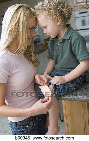 Side profile of a mother with her son View Large Photo Image Stock Photography - Side profile of a mother with her son. Fotosearch