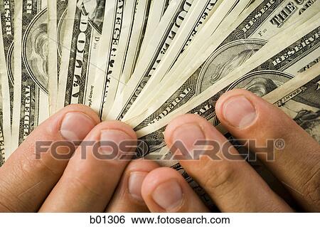 Close-up of hands holding money View Large Photo Image Stock Photograph - Close-up of hands holding money. Fotosearch