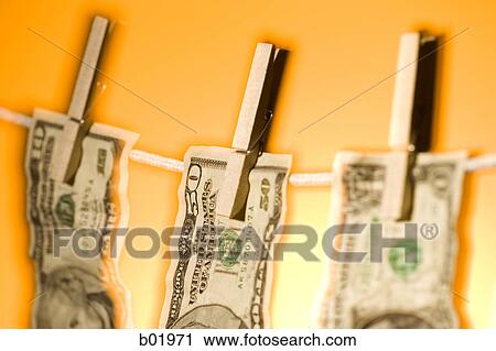 Stock Image - Close-up of money hanging on a clothes line. Fotosearch