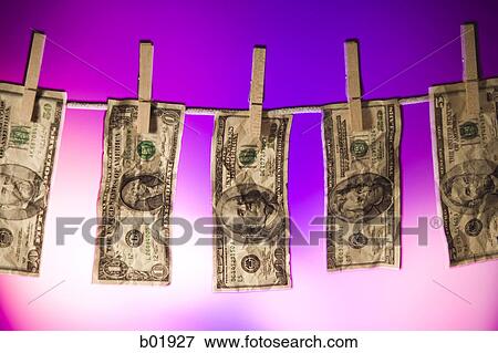 Stock Photo - Close-up of money hanging on a clothes line. Fotosearch
