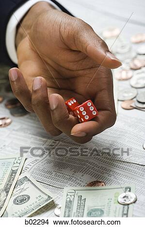 Picture - Man rolling dice. Fotosearch
