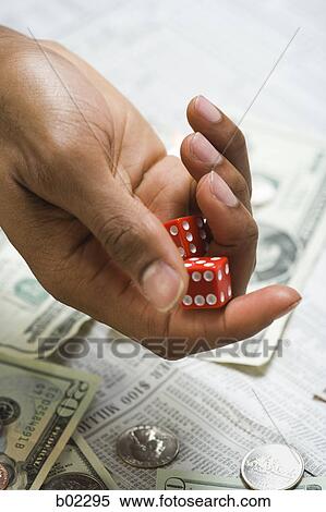 Stock Photography - Man rolling dice. Fotosearch