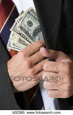 Mid section view of a businessman putting money in his pocket View Large Photo Image Stock Photography - Mid section view of a businessman putting money in his pocket. Fotosearch