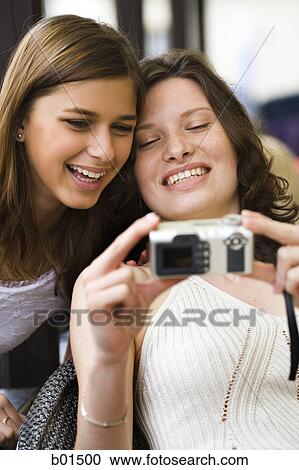 Close-up of two teenage girls taking a picture together View Large Photo Image Stock Image - Close-up of two teenage girls taking a picture together. Fotosearch