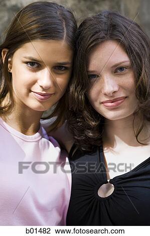Portrait of two teenage girls standing together View Large Photo Image Stock Image - Portrait of two teenage girls standing together. Fotosearch