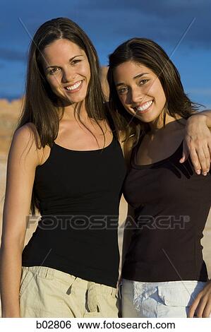 Stock Photograph - Portrait of two young women smiling. Fotosearch