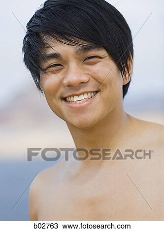 Close-up of a young man smiling View Large Photo Image Stock Image - Close-up of a young man smiling. Fotosearch