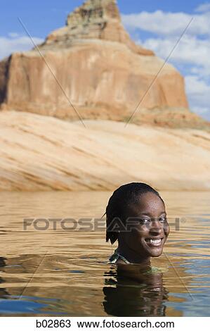 Portrait of a young woman smiling View Large Photo Image Stock Image - Portrait of a young woman smiling. Fotosearch