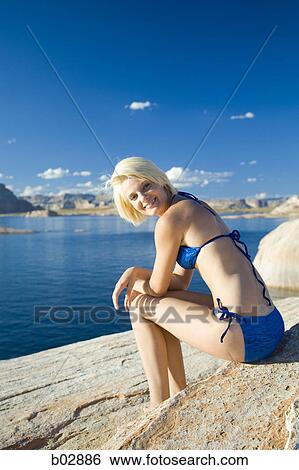 Profile of a young woman sitting on a lakeside View Large Photo Image Stock Photograph - Profile of a young woman sitting on a lakeside. Fotosearch