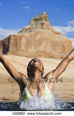 Young woman splashing in water View Large Photo Image Stock Image - Young woman splashing in water. Fotosearch