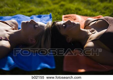 High angle view of two young women relaxing View Large Photo Image Stock Photography - High angle view of two young women relaxing. Fotosearch