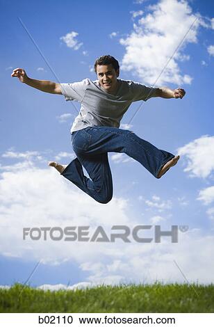 Portrait of a young man jumping View Large Photo Image Stock Image - Portrait of a young man jumping. Fotosearch