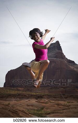 Portrait of a young woman jumping View Large Photo Image Stock Photograph - Portrait of a young woman jumping. Fotosearch