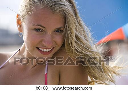 Stock Image - Portrait of a young woman smiling. Fotosearch