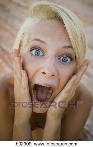 Portrait of a young woman with her mouth open View Large Photo Image Stock Photo - Portrait of a young woman with her mouth open. Fotosearch