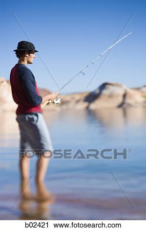 Profile of a young man fishing View Large Photo Image Stock Image - Profile of a young man fishing. Fotosearch